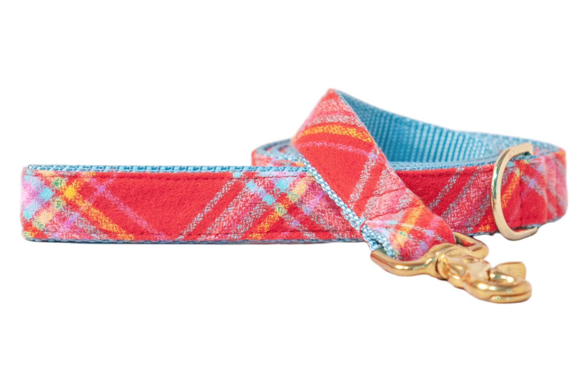 Colorful dog leash with a red plaid print on flannel accented by pastel stripes. The interior webbing is nylon, finished with polished hardware including a swivel snap hook and D-ring.