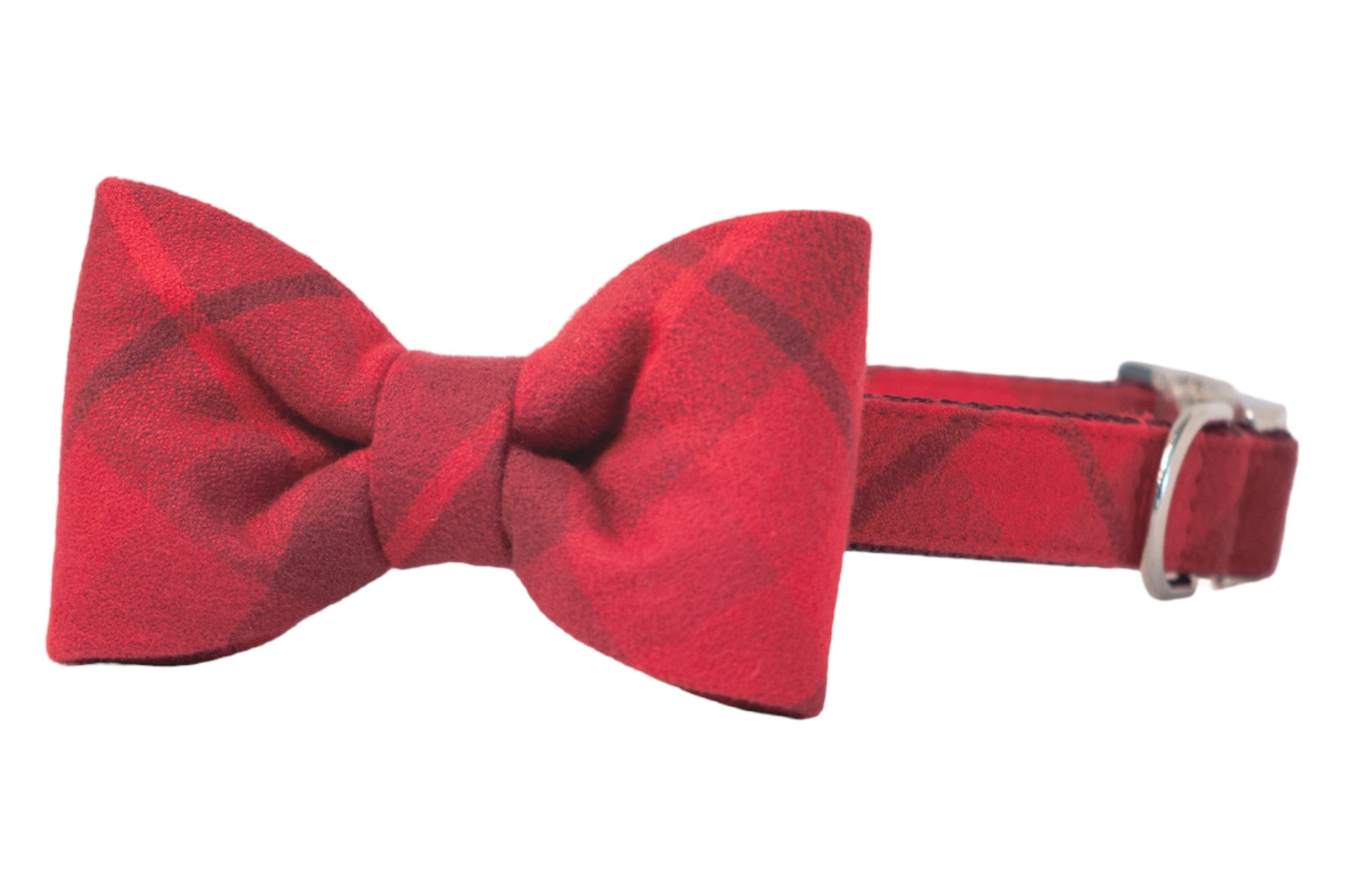 Red plaid dog collar with an attached structured bow tie, crafted from soft flannel with sleek hardware—perfect for adding refined charm to any pup’s look.