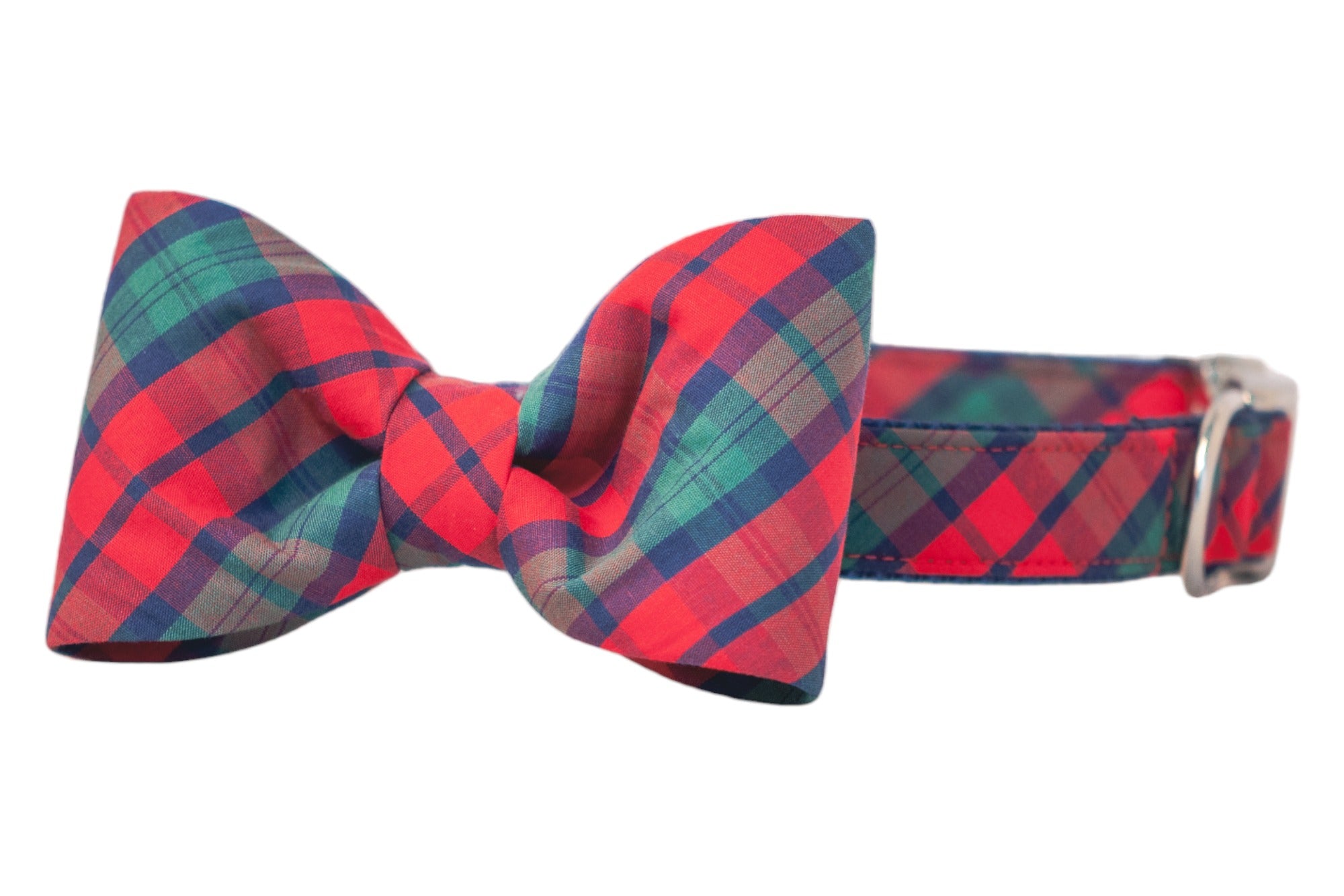 A festive plaid dog collar with a coordinating bow tie. The structured bow is securely affixed to the collar, which features reinforced stitching and a metal loop for functionality. Ideal for stylish pets or holiday occasions.