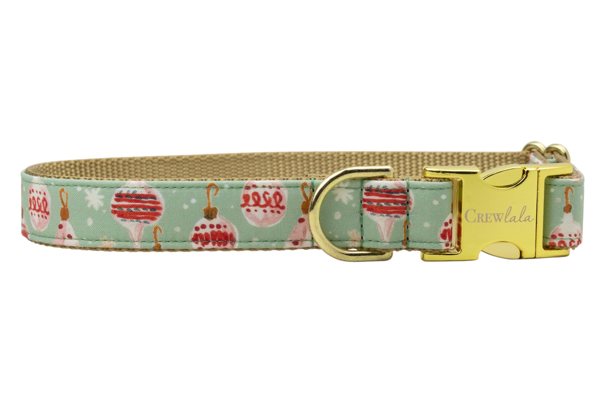 A festive dog collar with a pale green fabric exterior featuring Christmas ornaments, hooks, and snowflakes. The inner lining is durable nylon webbing. The collar includes sturdy hardware: a D-ring, adjustable sizing slider, and a side-release buckle engraved with the brand name “Crewlala.”